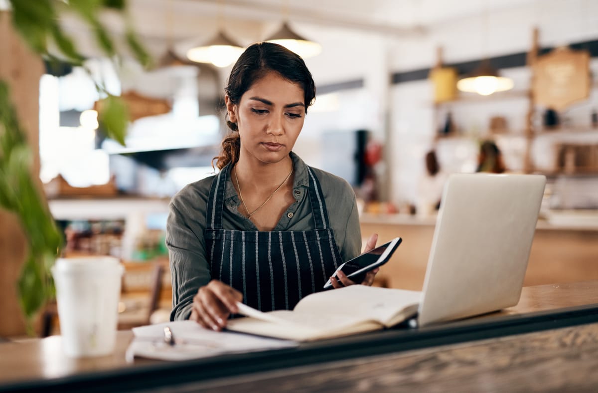 Restaurant worker on laptop internet local seo research