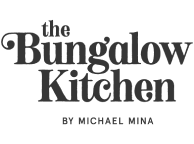 On transparent background is written with black letters "The Bungalow Kitchen by Michael Mina"