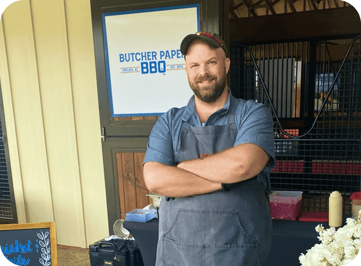 Mark Coxwell - the owner of Butcher Paper BBQ interviewed in front of his restaurant with a butcher paper background