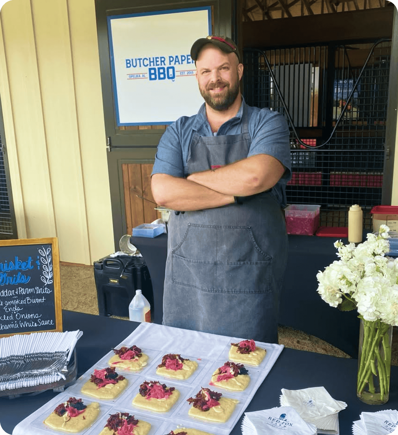 Mark Coxwell - the owner of Butcher Paper BBQ interviewed in front of his restaurant with a butcher paper background