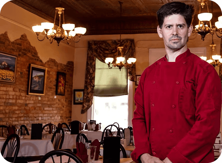 Adam Reed, Chef & Owner of Santé, standing in the dining room