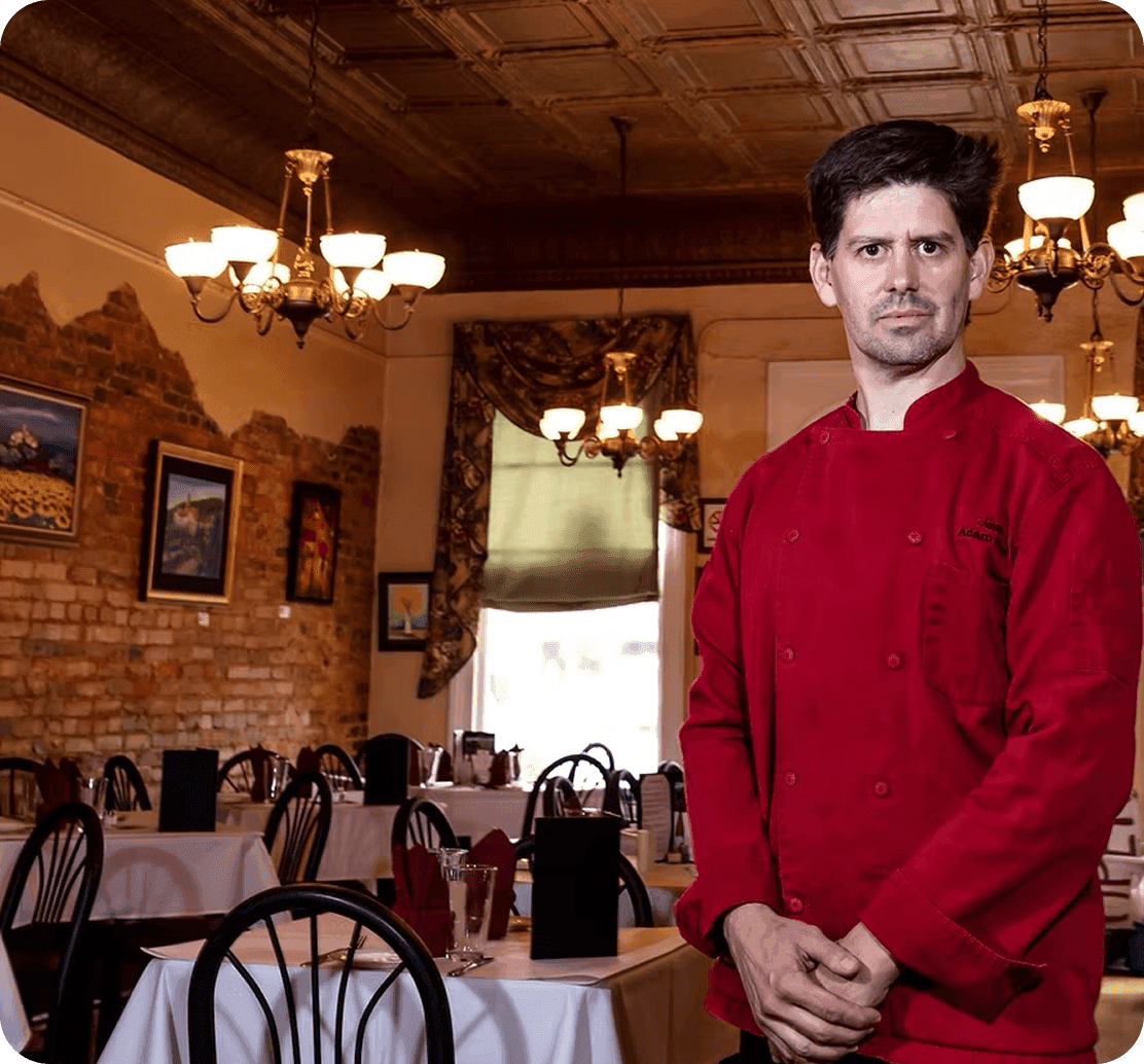 Adam Reed, Chef & Owner of Santé, standing in the dining room