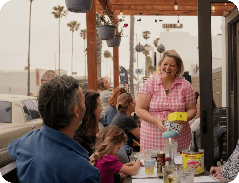 Roxana Pavel, Owner of Allmine, talking with guests on the patio