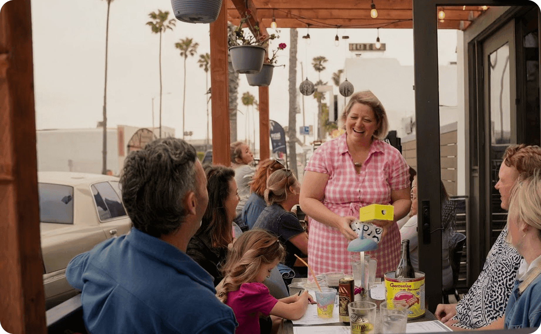 Roxana Pavel, Owner of Allmine, talking with guests on the patio