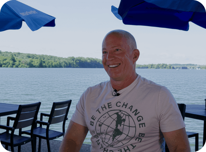Man talking in front of a lake