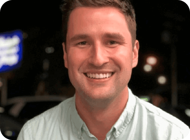 Brenton Woodruff, COO of Café Ficelle, smiling in a light green shirt