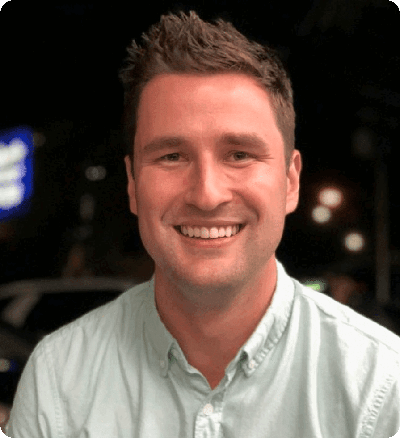 Brenton Woodruff, COO of Café Ficelle, smiling in a light green shirt