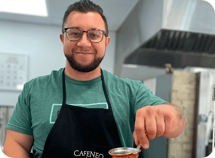Tony Fessaras, owner of Cafeneo, preparing traditional coffee in the café