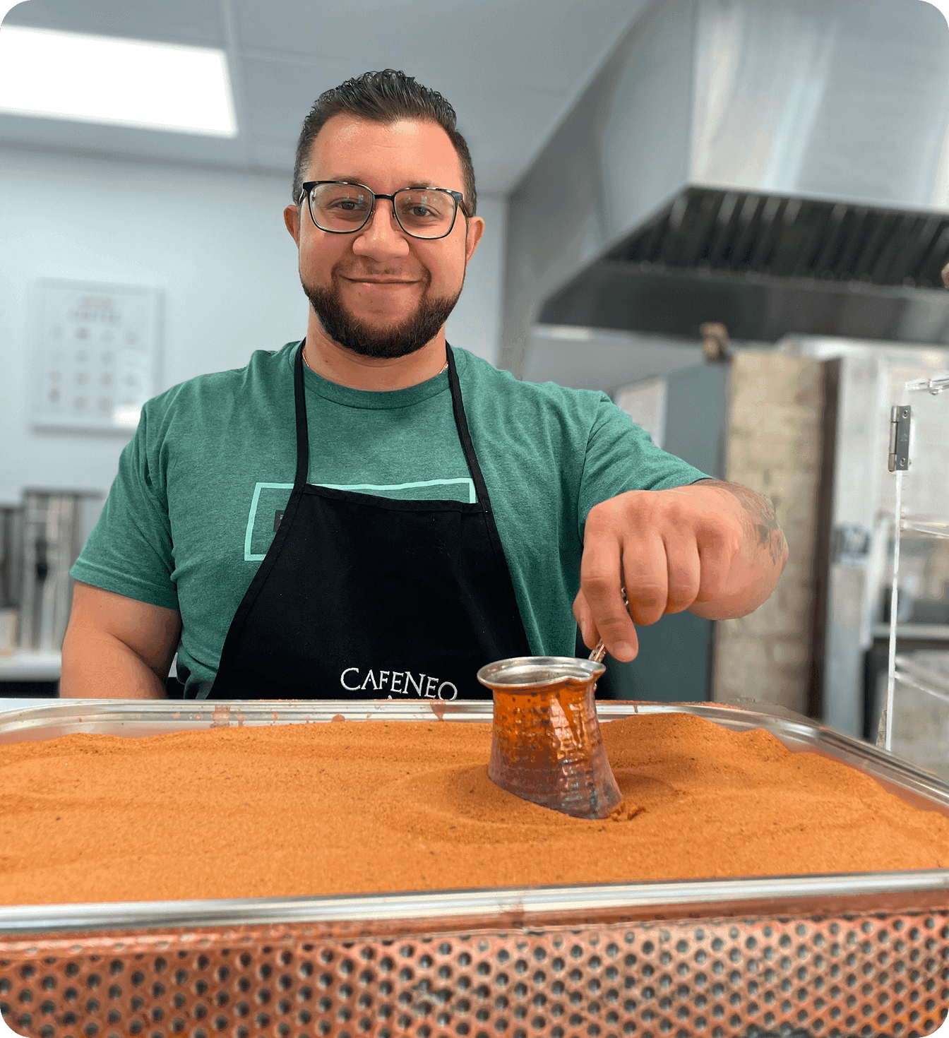 Tony Fessaras, owner of Cafeneo, preparing traditional coffee in the café