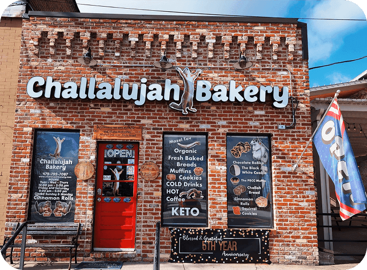 Exterior of Challalujah Bakery with brick facade, signage, and storefront displays