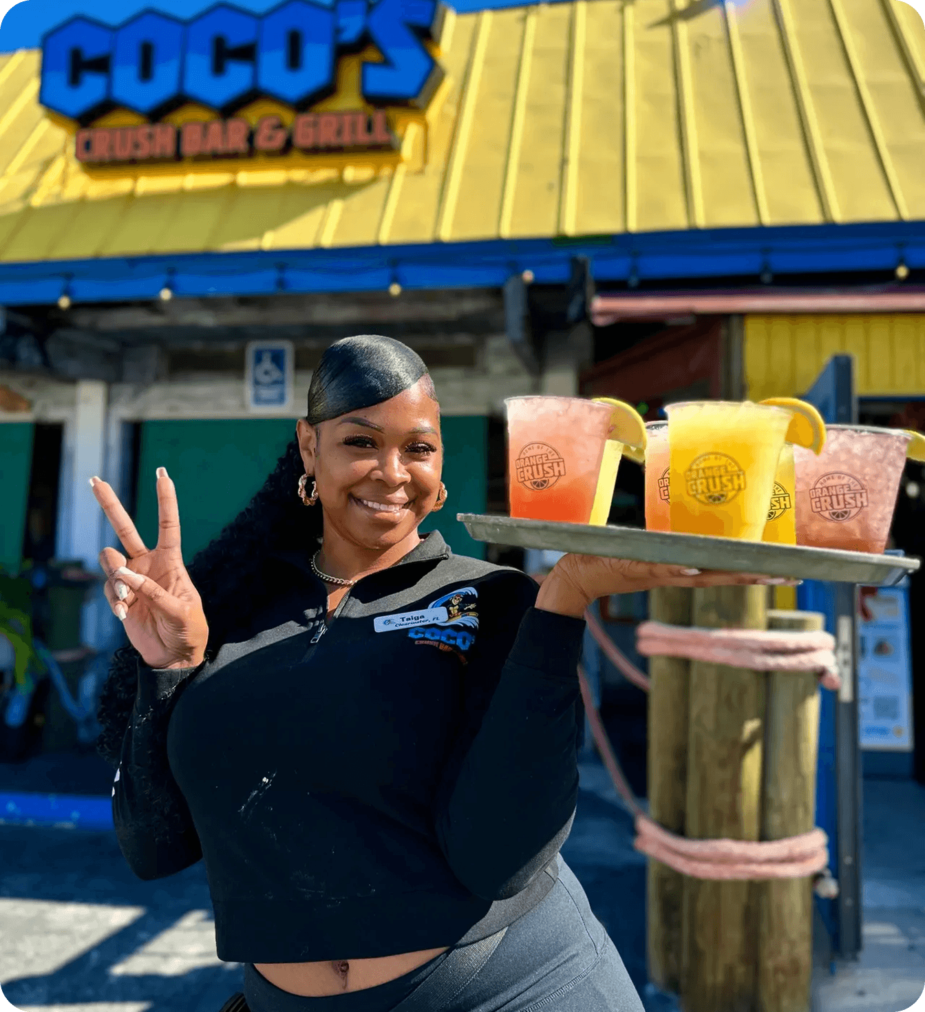 Coco’s Crush Bar & Grill orange crush drink served outdoors in branded cup