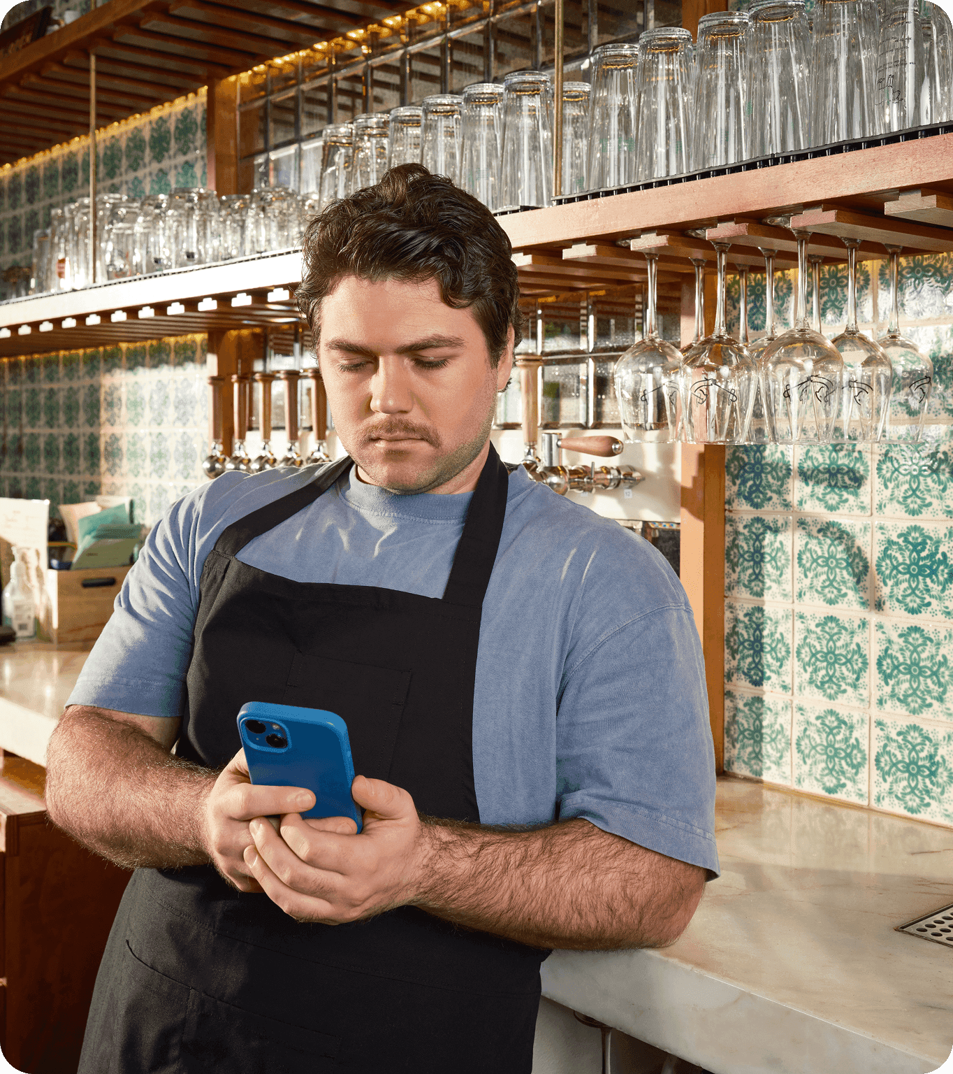 A restaurant server looks at their earned tips from the DayCheck mobile app