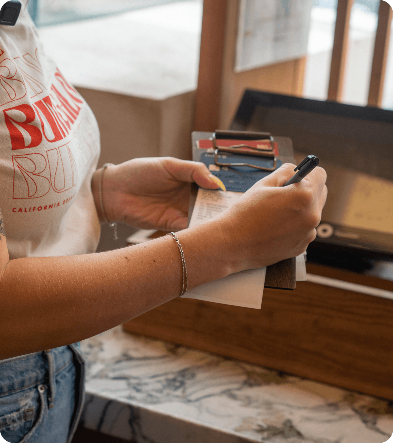 A restaurant workers looks at their tip transfer options from the DayCheck mobile app