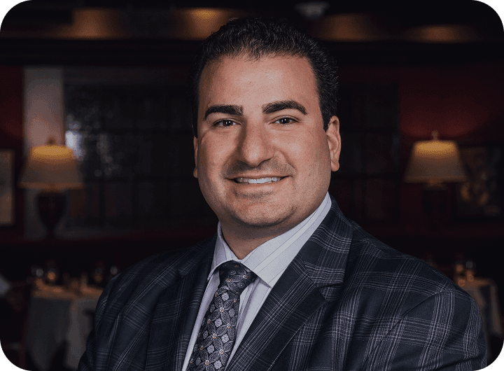 Vicari of Joe Vicari Restaurant Group smiling in a suit