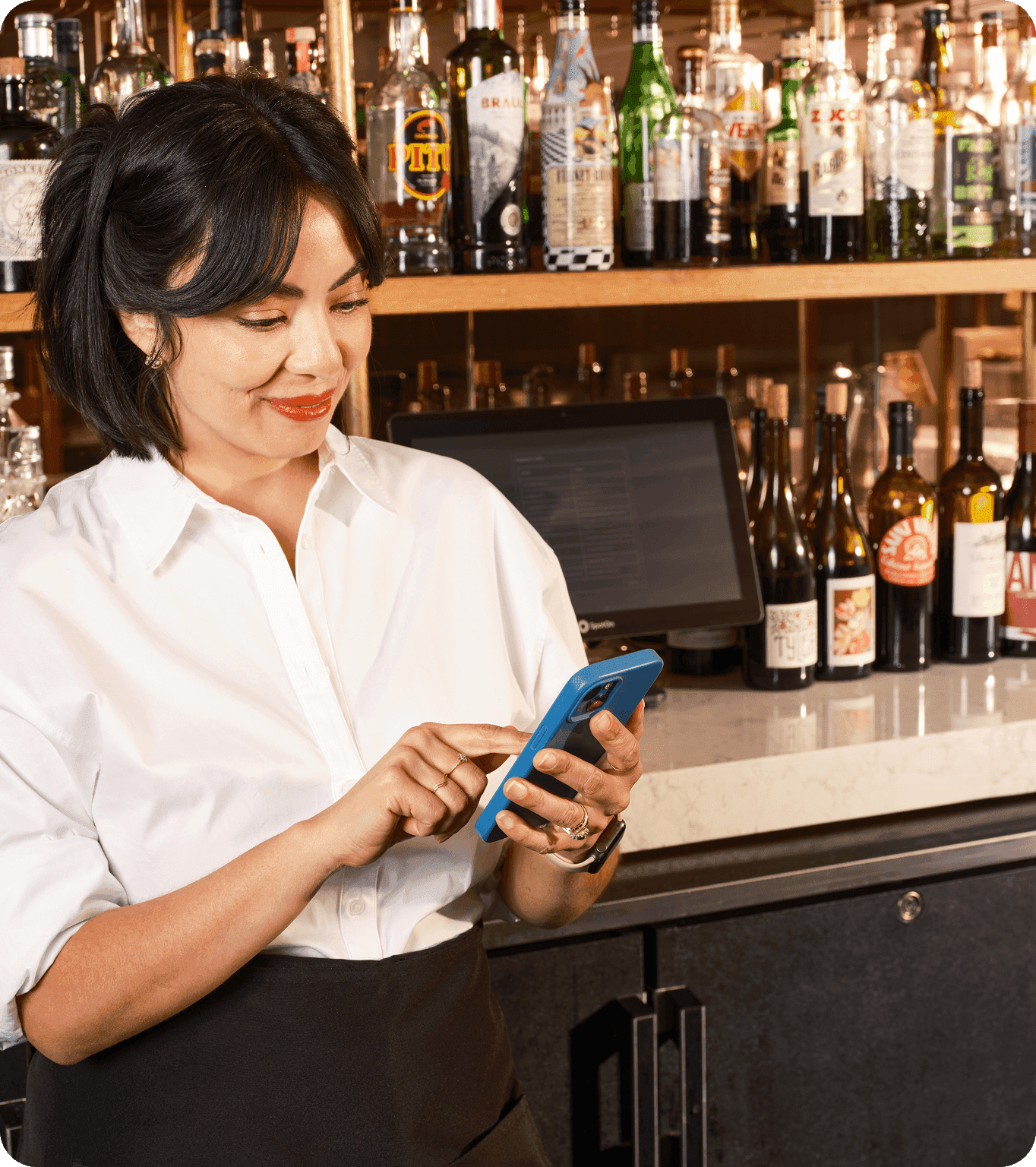 Restaurant employee looks at their upcoming shifts on their phone