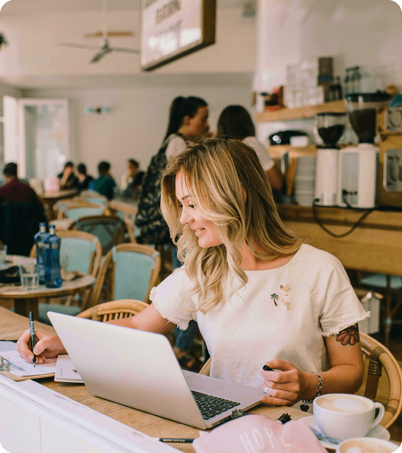 Restaurant manager reviews employee schedules on a computer