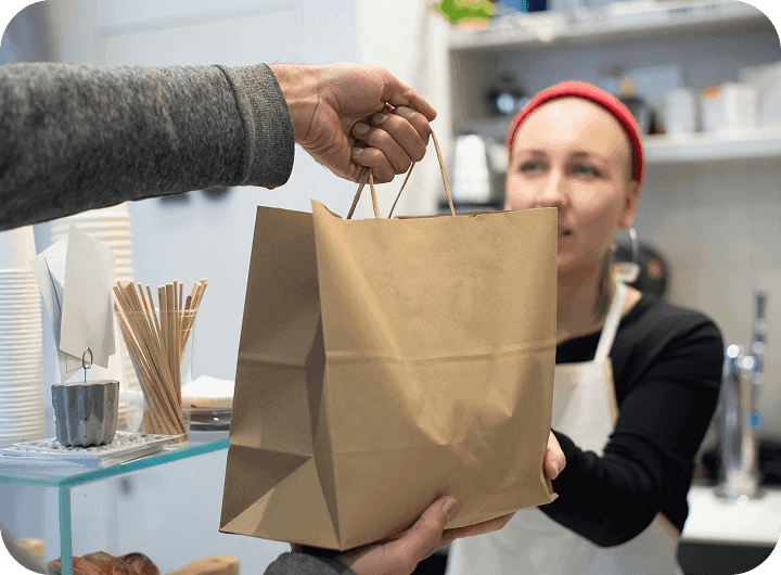A customer leaves their favorite restaurant with a to-go bag
