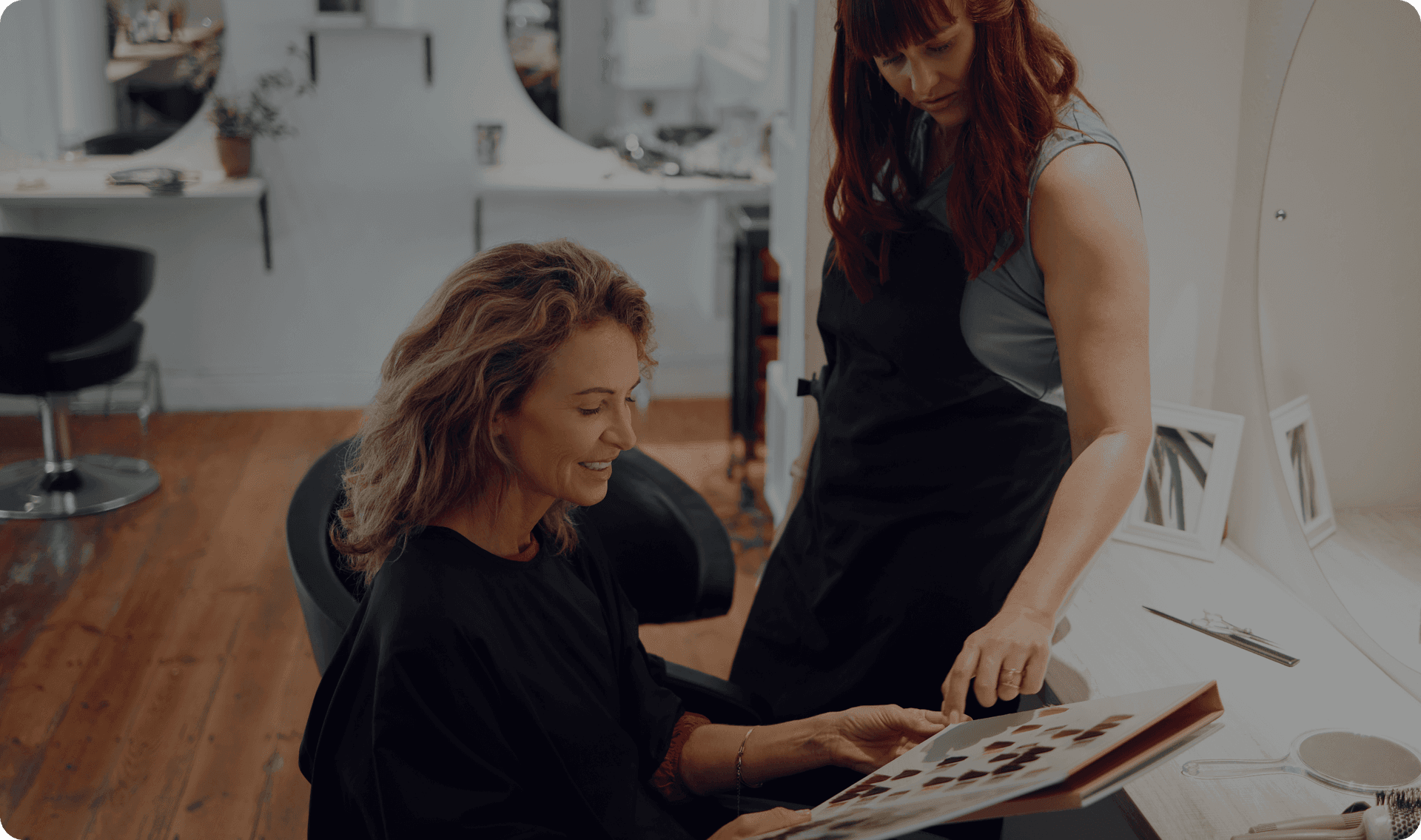 A hair salon worker works with a customer