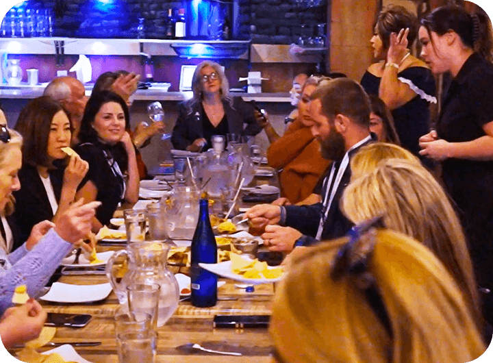 A large group gathers around a table at Urban Roast
