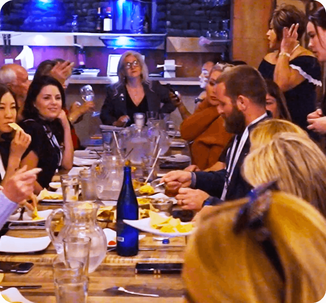 A large group gathers around a table at Urban Roast