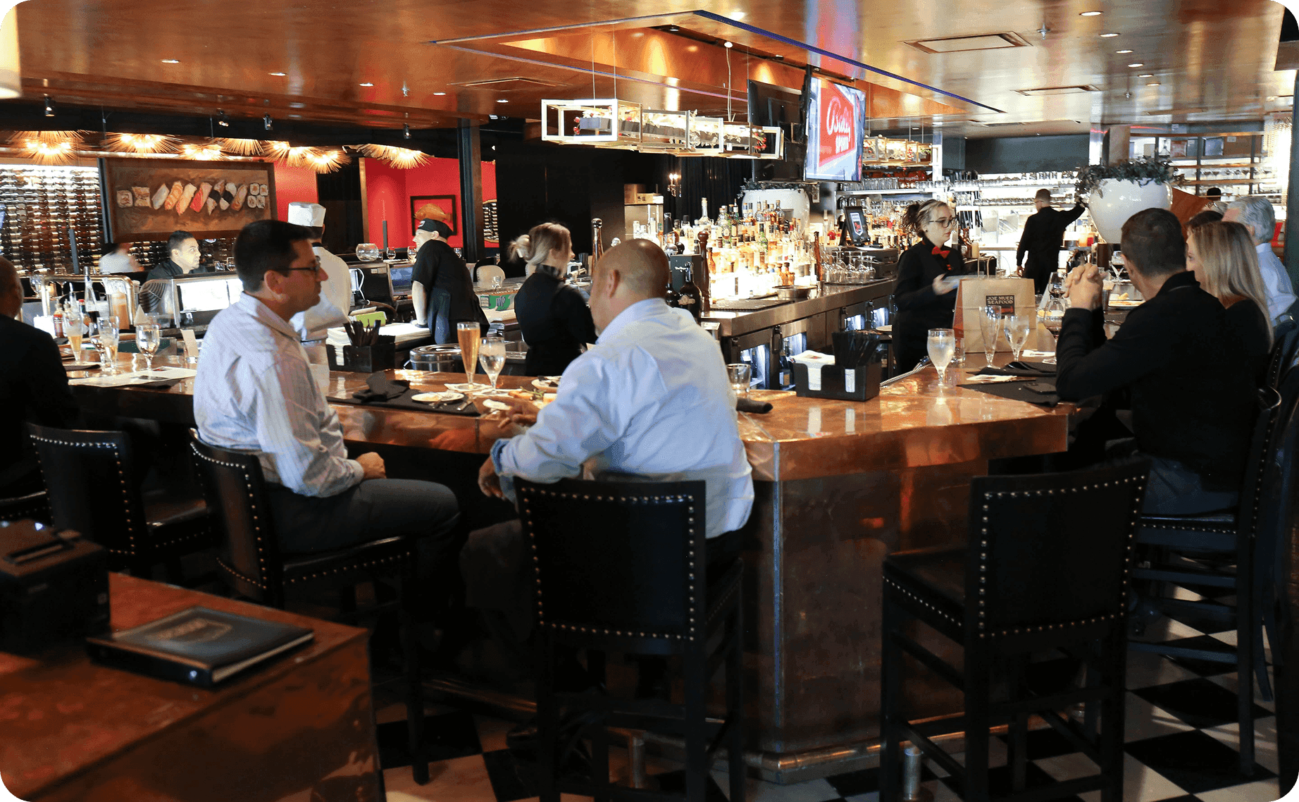 Guests seated at the bar at Joe Muer