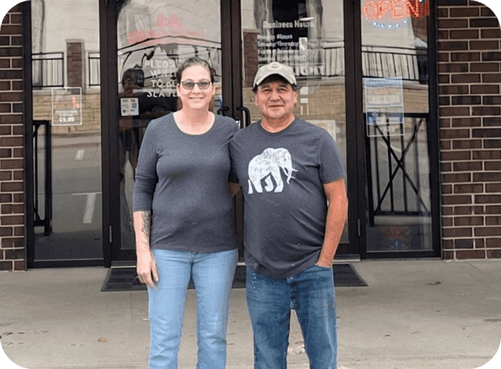 The owners of La Chiva Loka standing outside the restaurant entrance