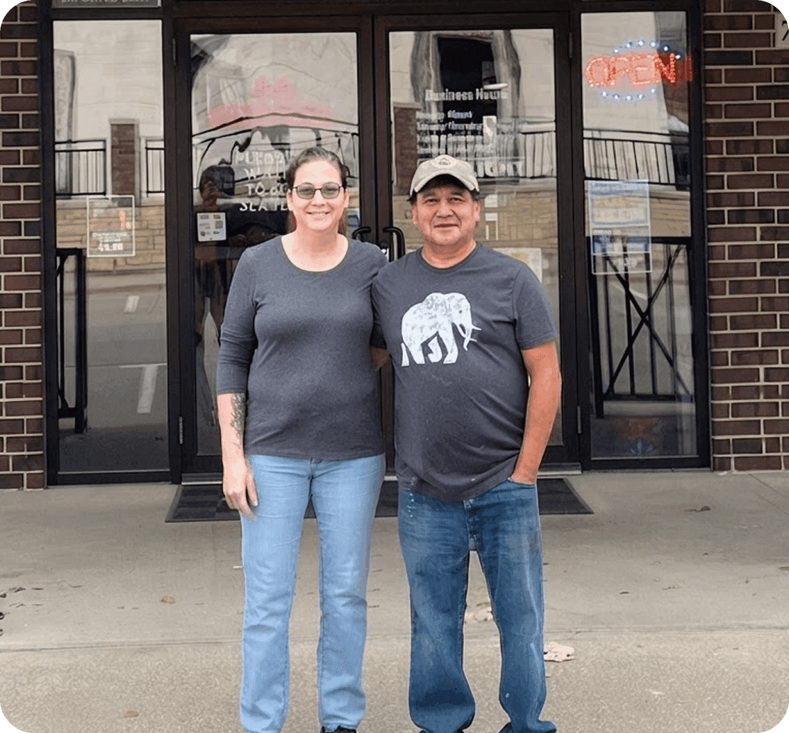 The owners of La Chiva Loka standing outside the restaurant entrance