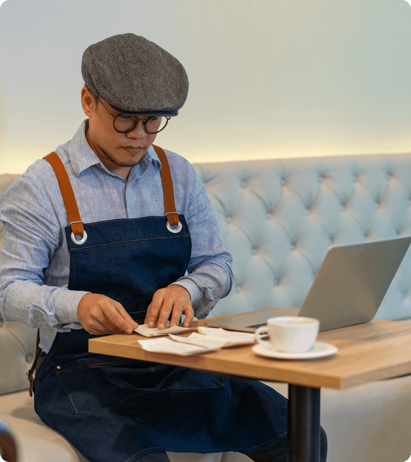 A restaurant manager approves tip payouts for employees right from a laptop