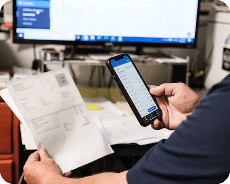 User reviewing invoices on phone synced with accounting integration
