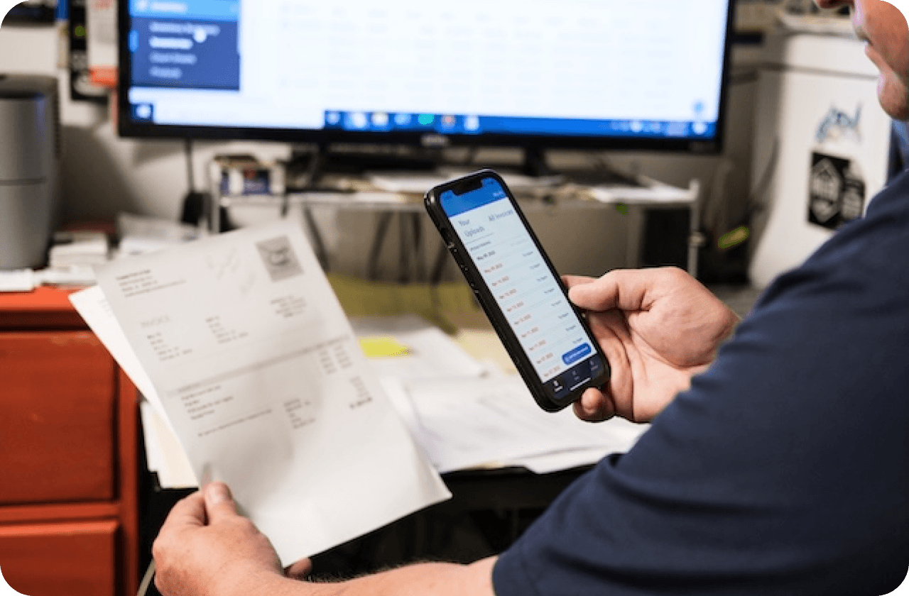 User reviewing invoices on phone synced with accounting integration