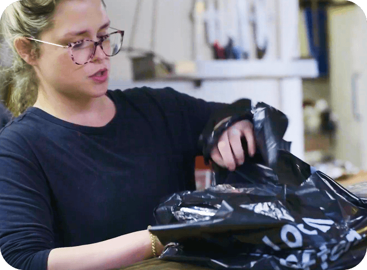Employee at Butcher Paper BBQ packing an online order
