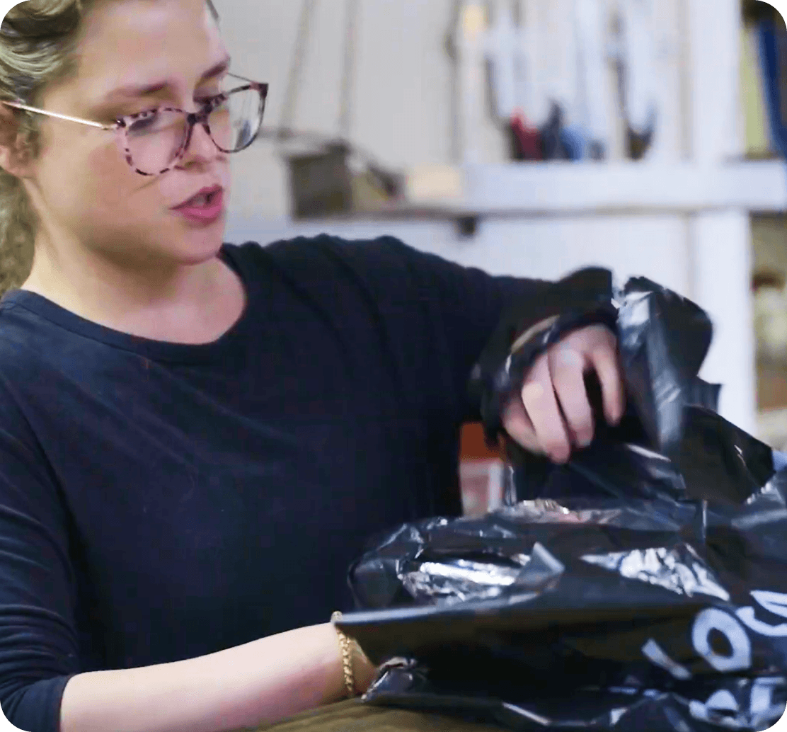 Employee at Butcher Paper BBQ packing an online order
