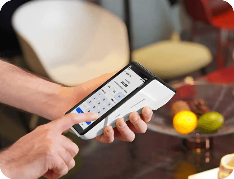 A small business employee runs a payment on a POS terminal