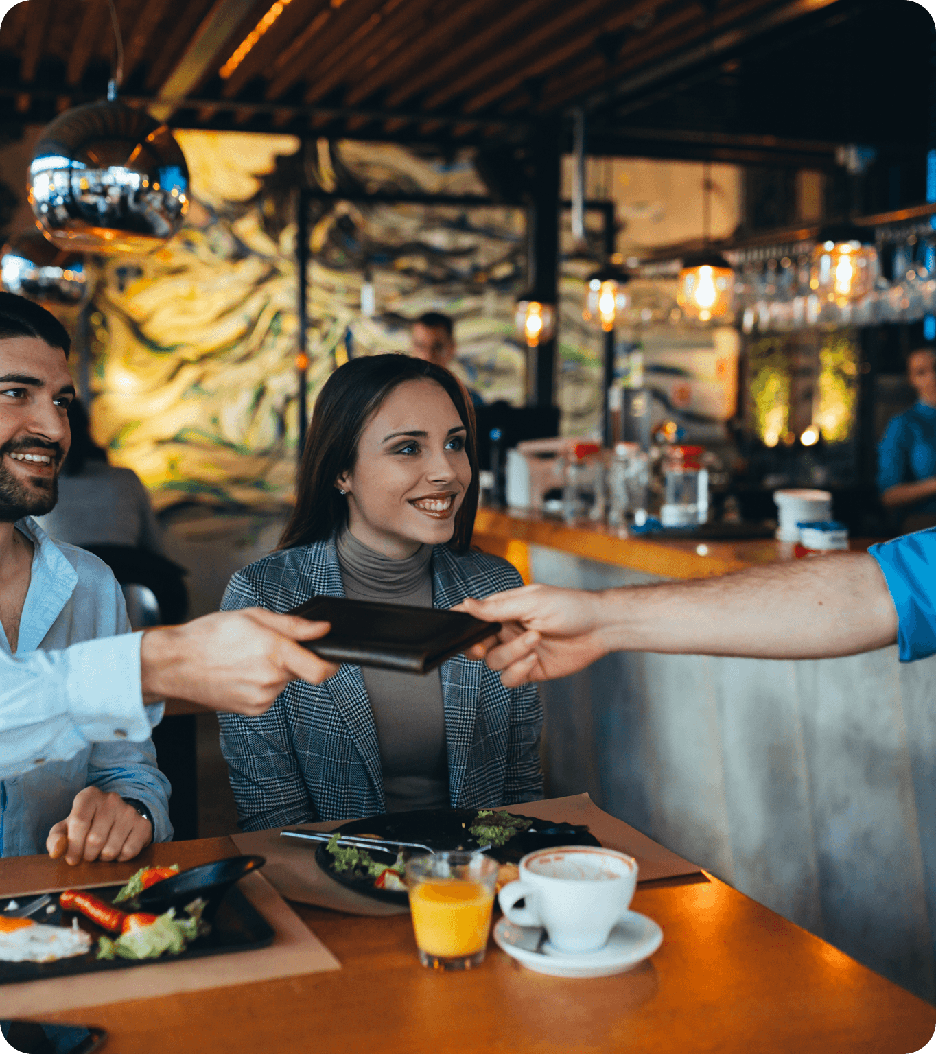 A restaurant customer pays for their meal with cash