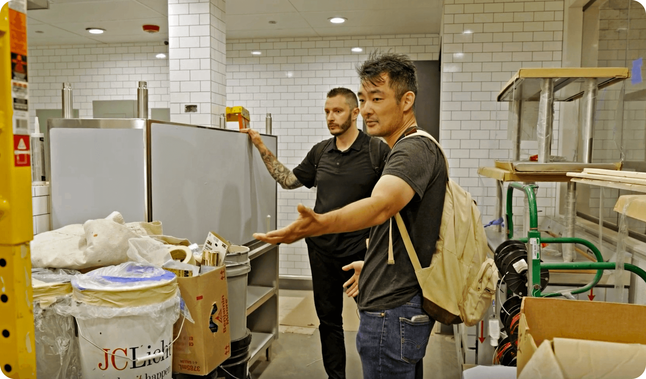 A restaurant owner observes construction work as they improve their business with funds from a restaurant loan