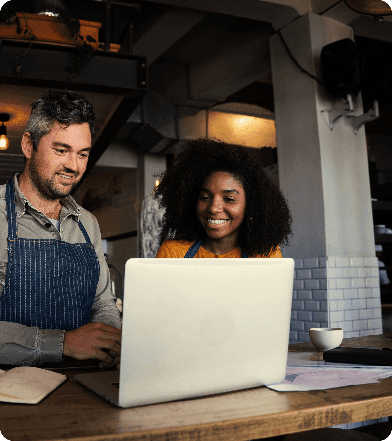 Restaurant manager reviewing employee tip payout info on a laptop