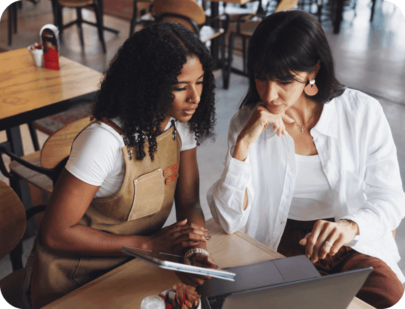 Restaurant manager reviews their SpotOn marketing dashboard on a laptop.
