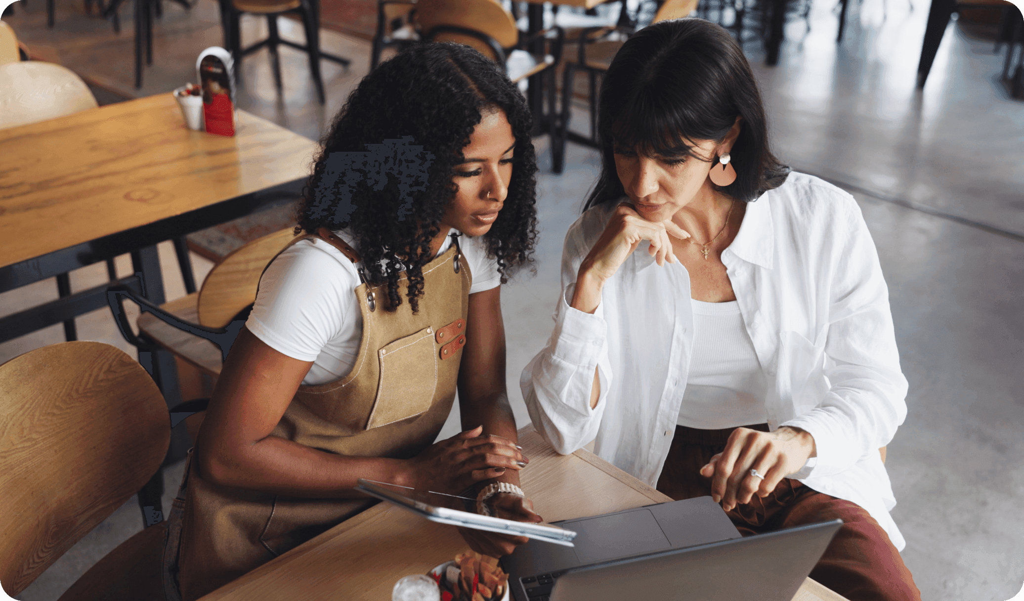 Restaurant manager reviews their SpotOn marketing dashboard on a laptop.