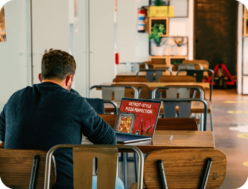 A restaurant owner looks at their new website on a computer screen
