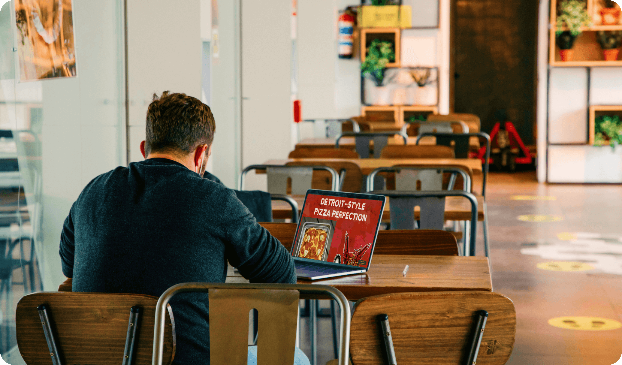 A restaurant owner looks at their new website on a computer screen