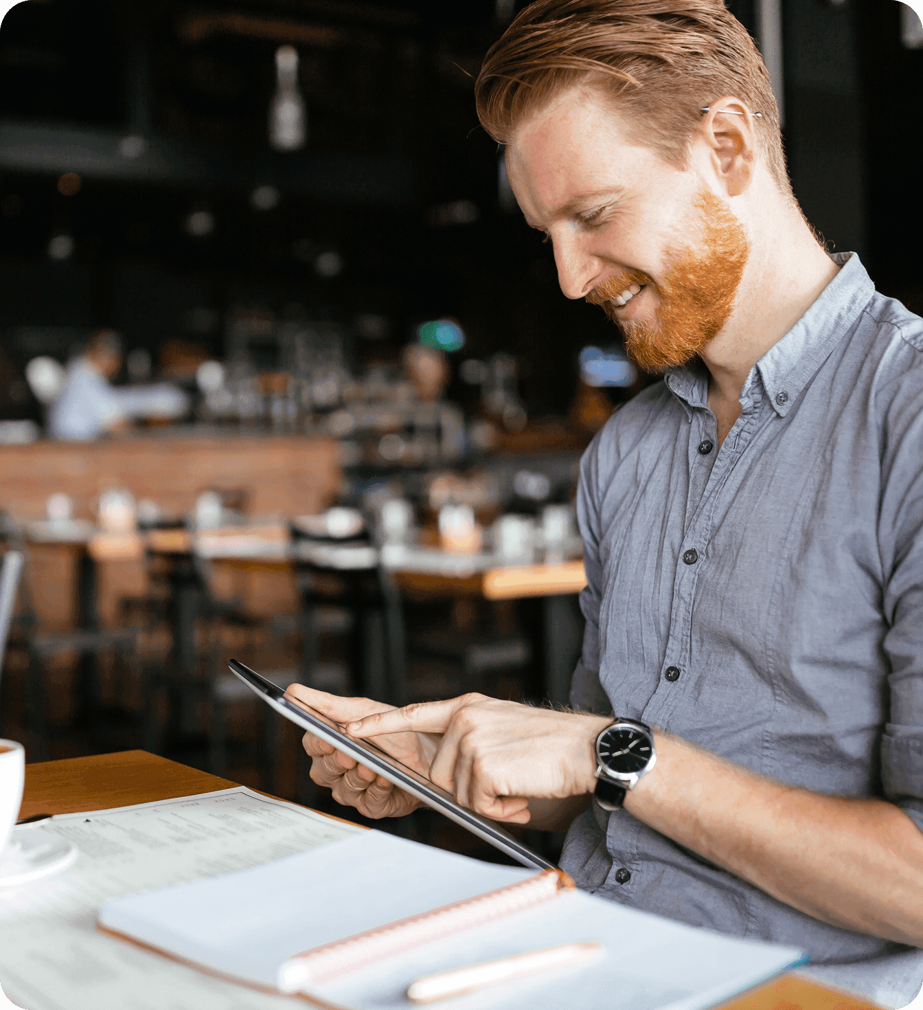 Restaurant manager at a table using and iPad