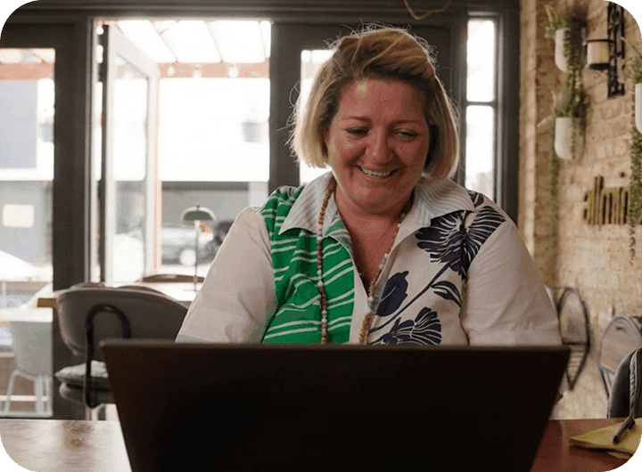 Roxana Pavel, Owner of Allmine, working on a laptop