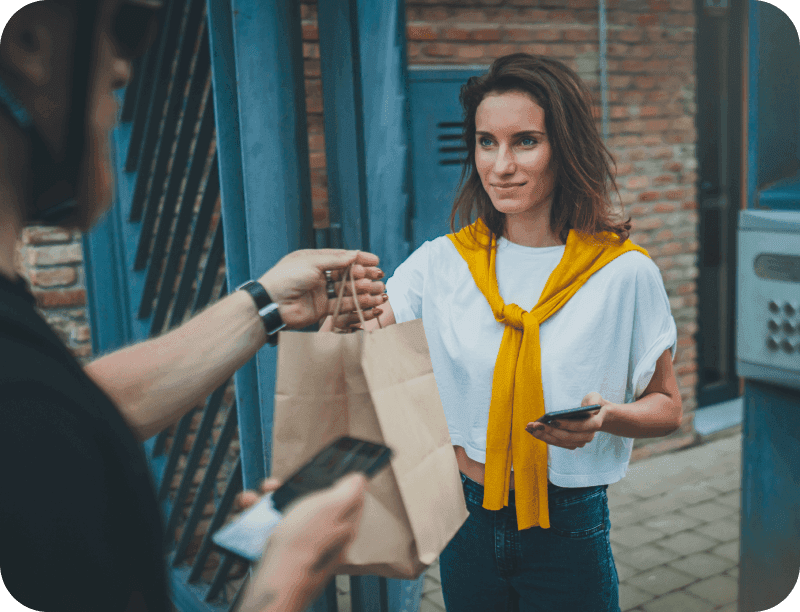 A delivery driver drops off a food order from a restaurant