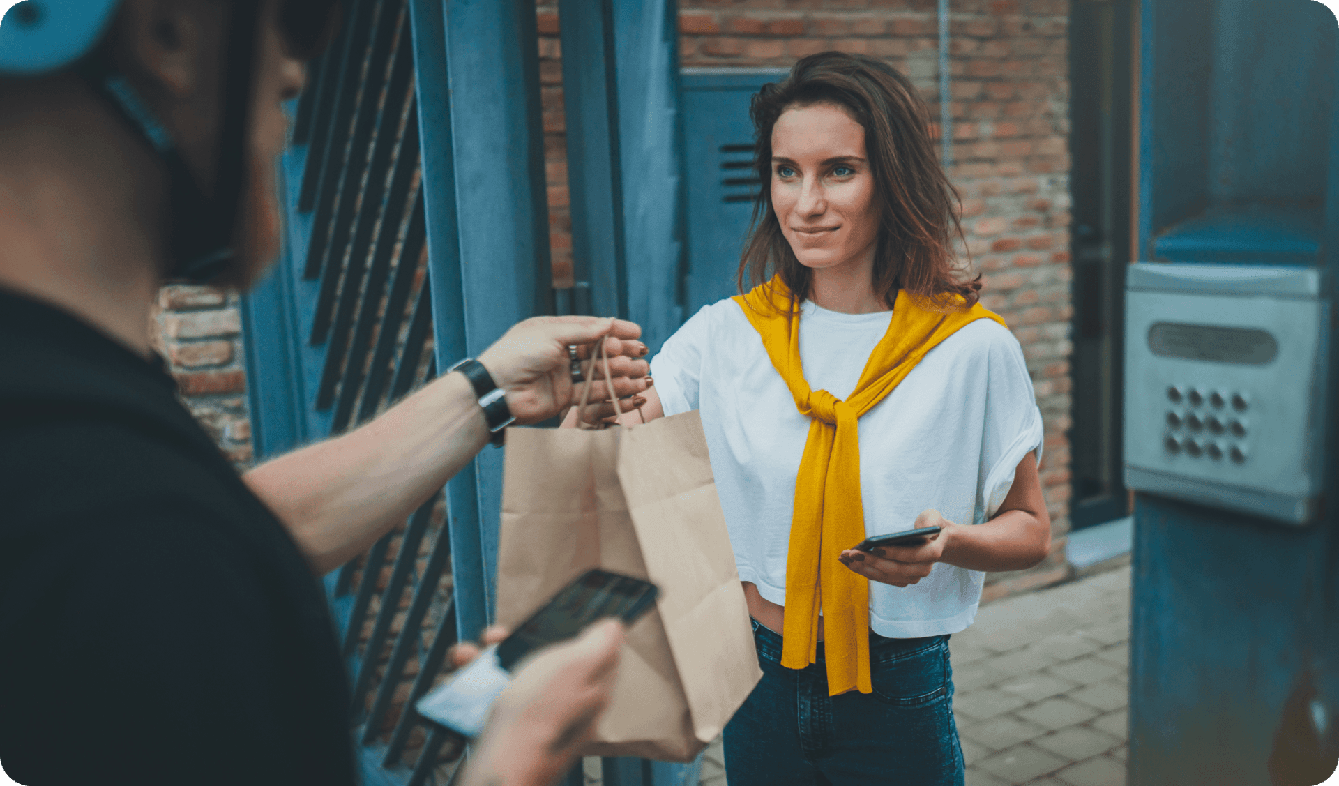 A delivery driver drops off a food order from a restaurant