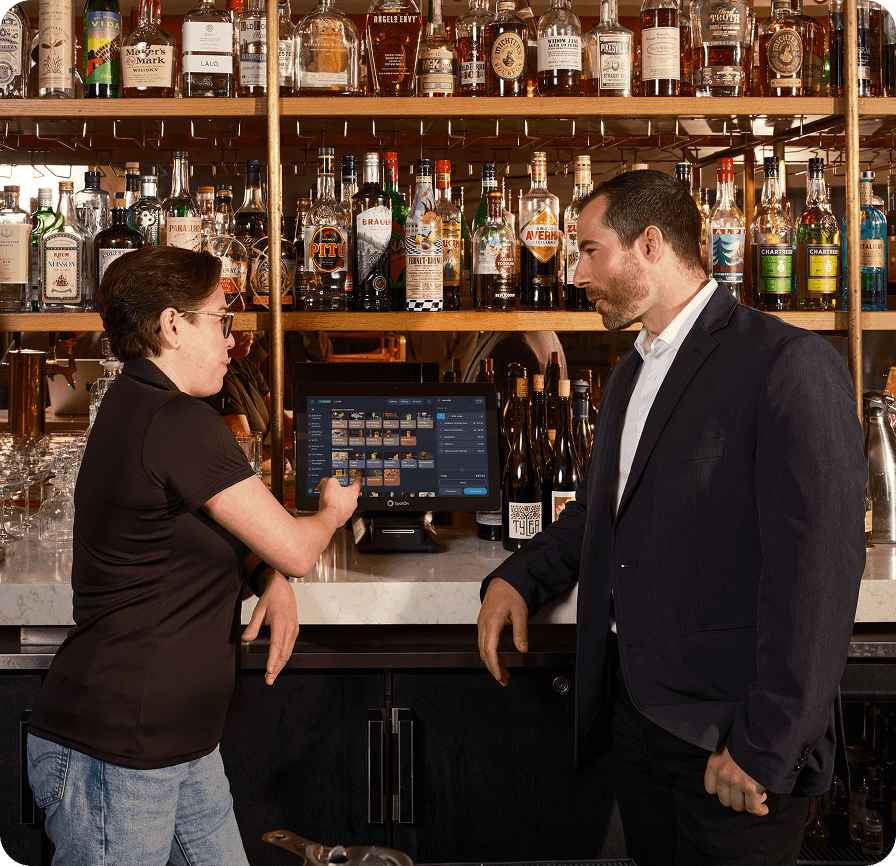 F3 installer training a restaurant server on the SpotOn POS system at Adalina restaurant