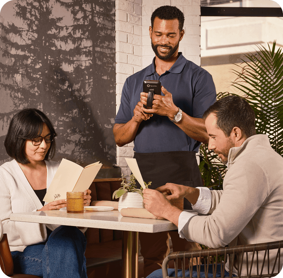 Server taking an order on SpotOn Handheld in a casual dining restaurant