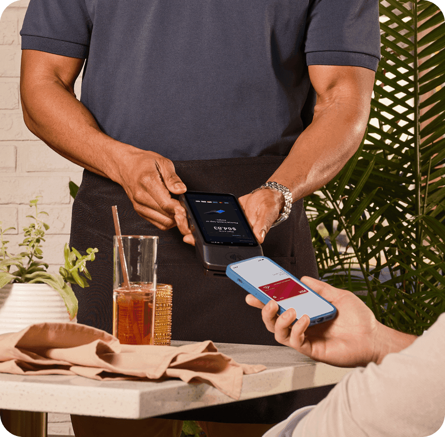 Server taking a payment on SpotOn Handheld in a casual dining restaurant