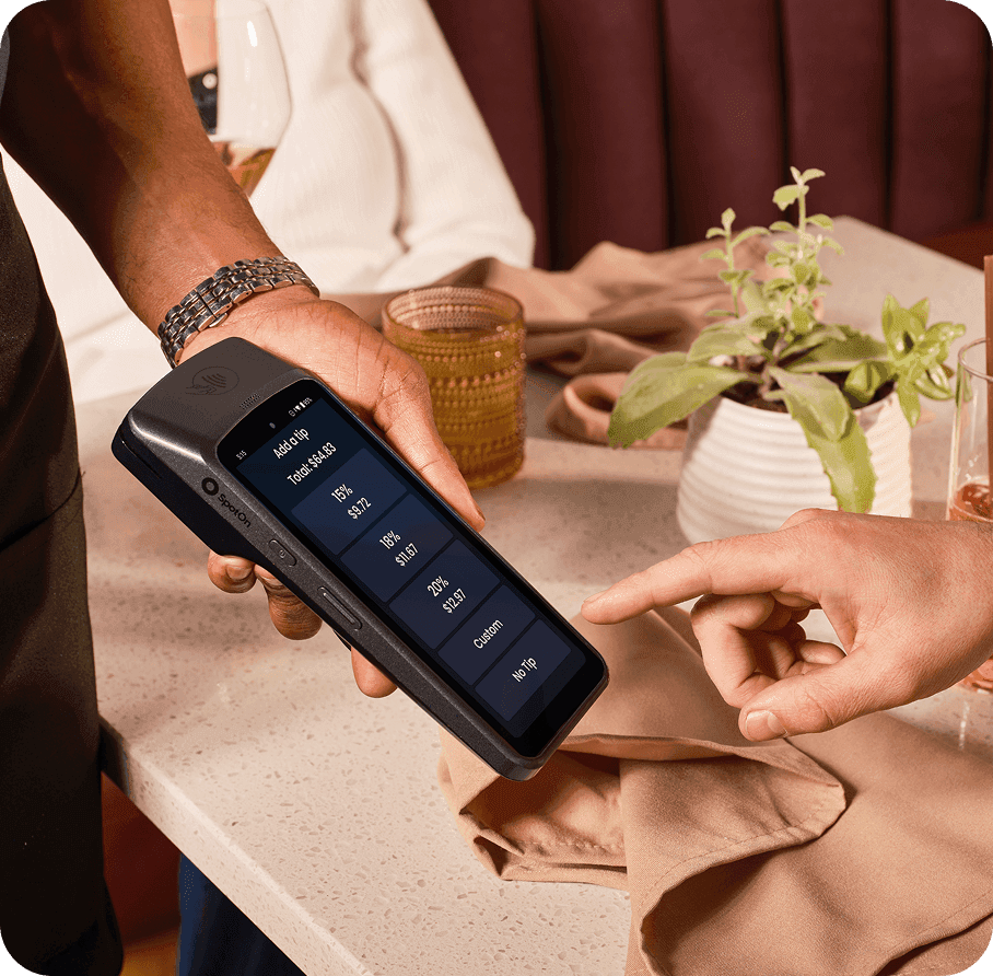 Guest giving a tip on SpotOn Handheld in a casual dining restaurant