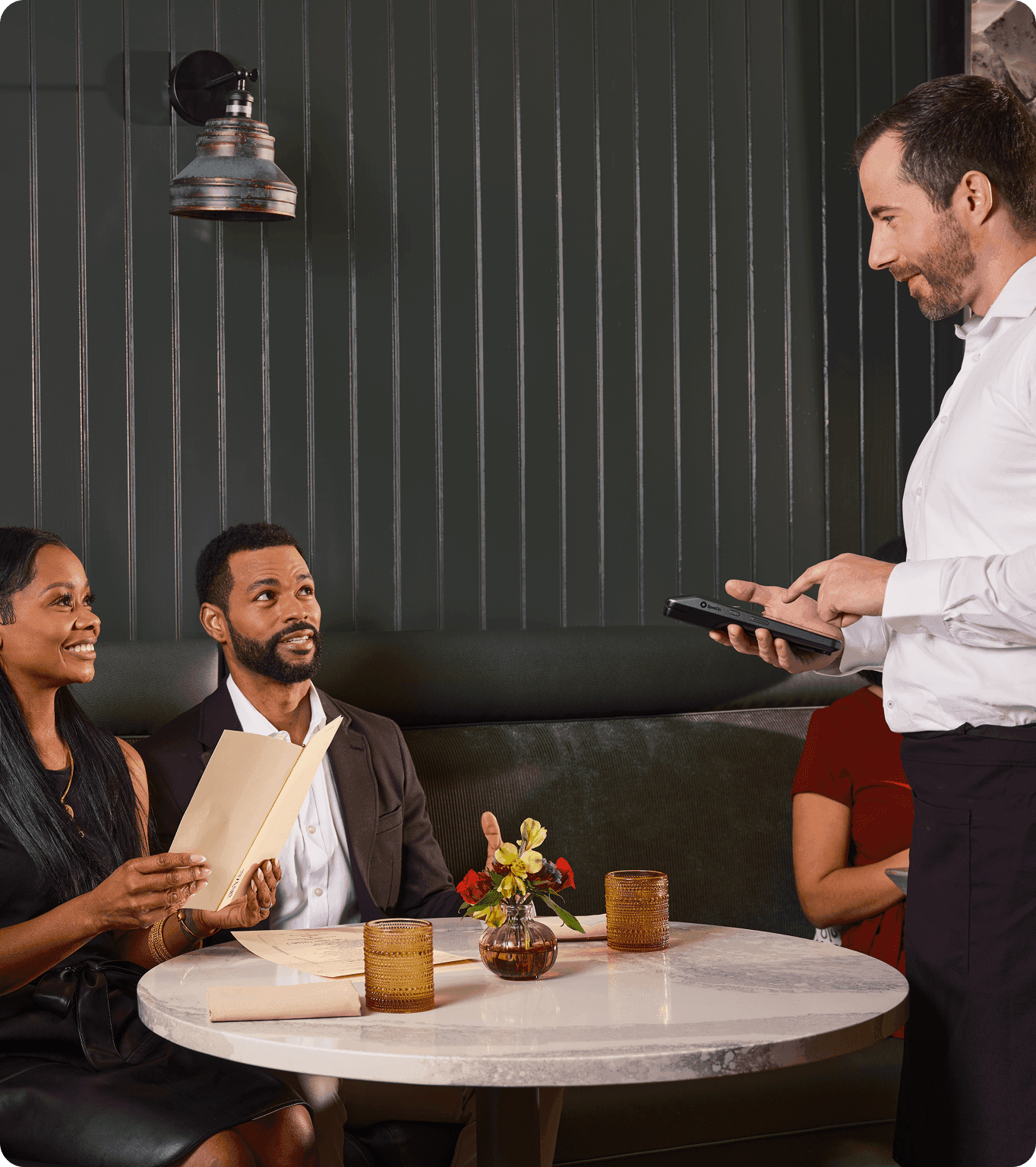 Server taking an order with SpotOn Handheld at a fine dining restaurant