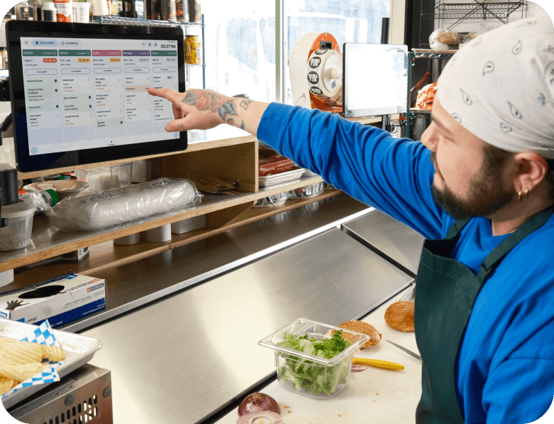 Cooks using SpotOn KDS in a kitchen of a casual dining restaurant